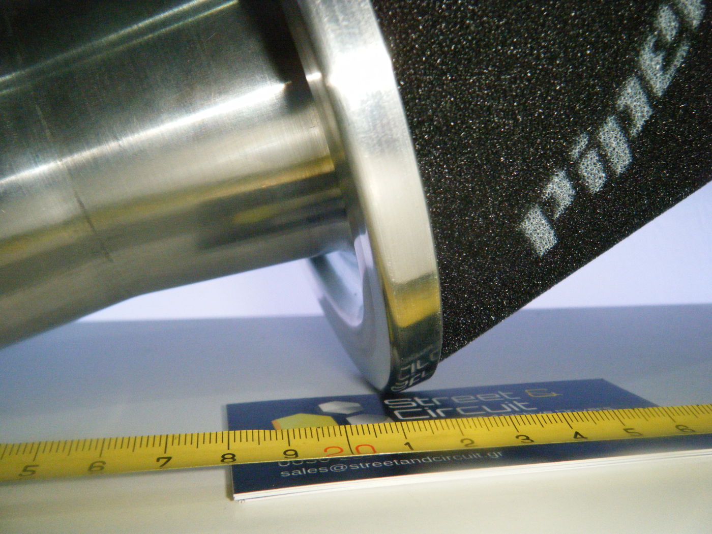 Picture of a cone filter on its side with a tape measure